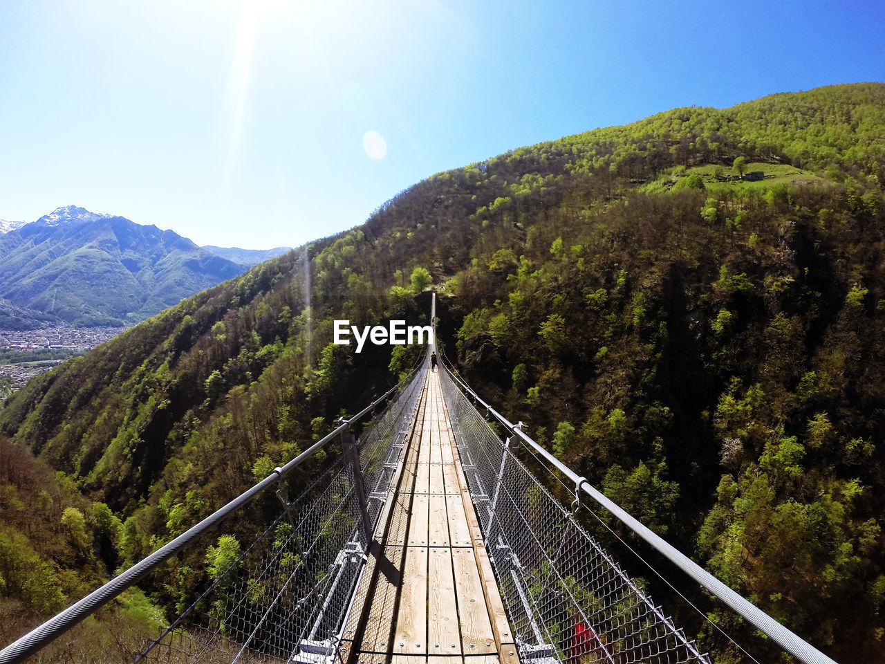 Dramatic tibetan bridge suspended 426 ft. above a forested mountain gorge with scenic views.