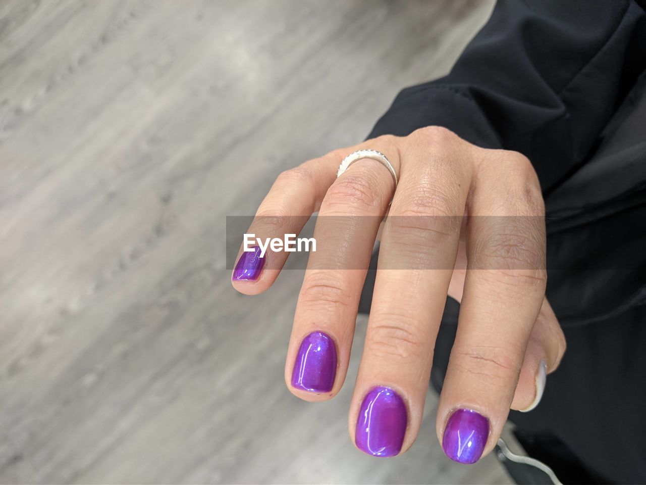 Close-up of woman hand on purple wall