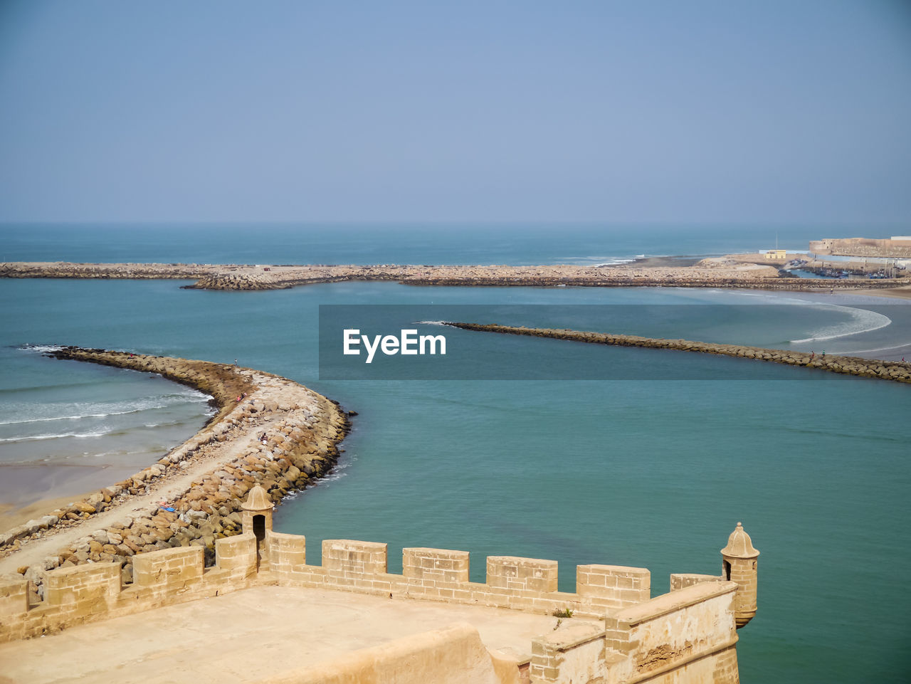 Scenic view of sea against clear blue sky