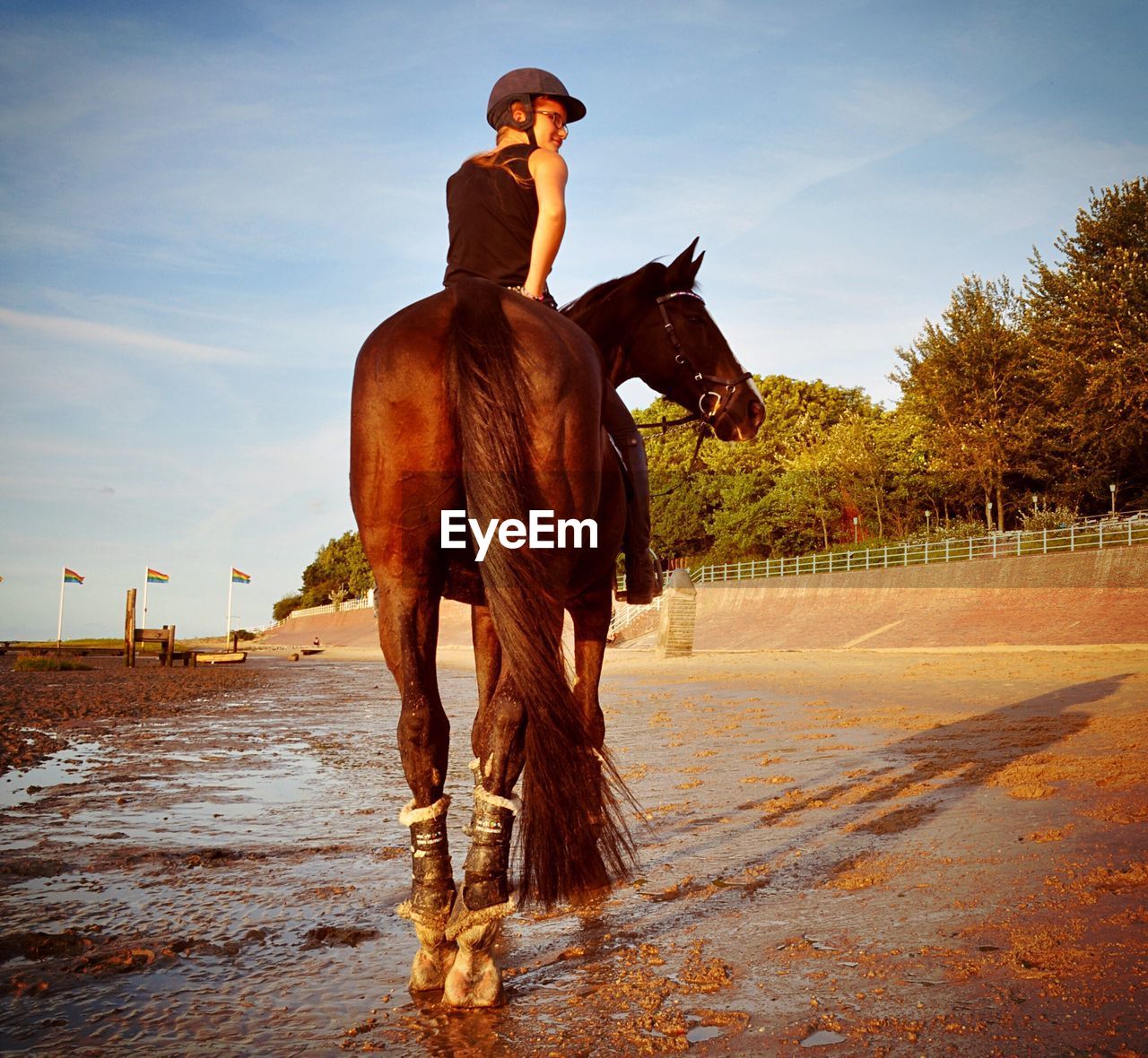 MAN RIDING HORSE ON BEACH