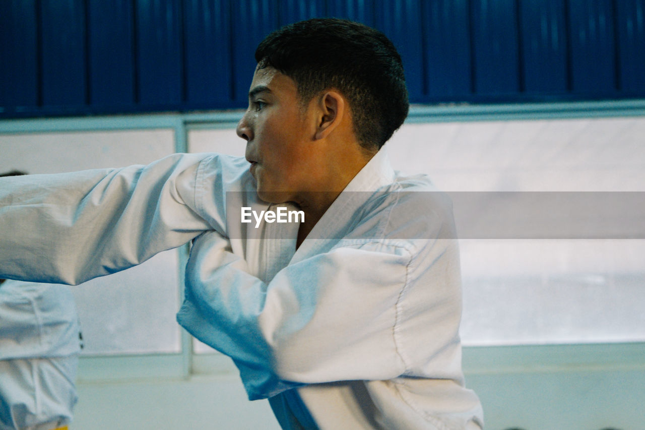 Close-up portrait of taekwondo student punching