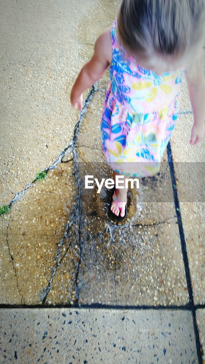 Girl splashing in puddle