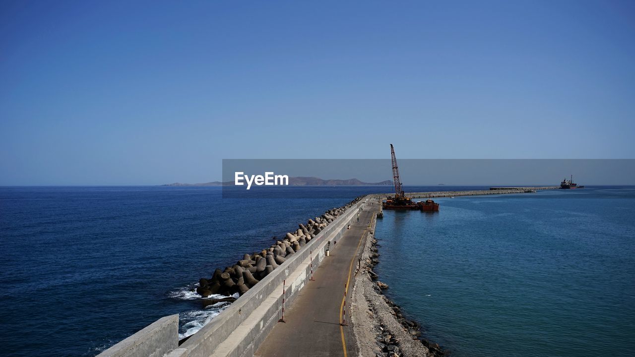 Scenic view of sea against clear blue sky