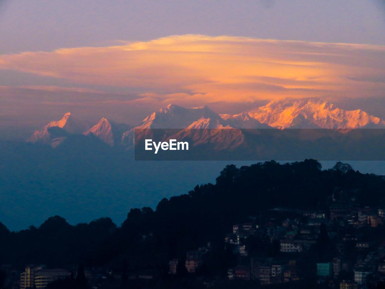 Scenic view of silhouette mountains against romantic sky at sunset