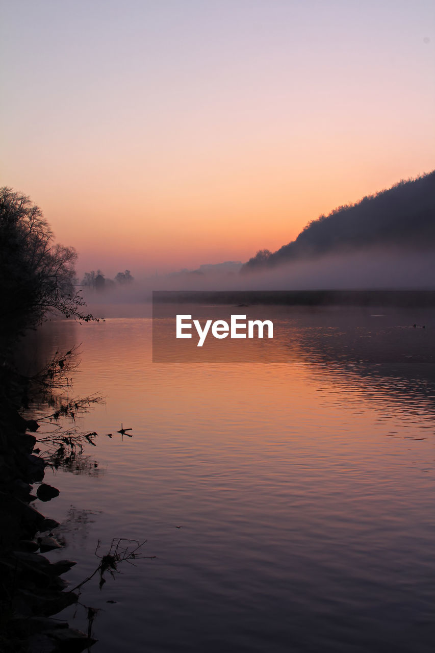 Scenic view of lake against sky during sunset