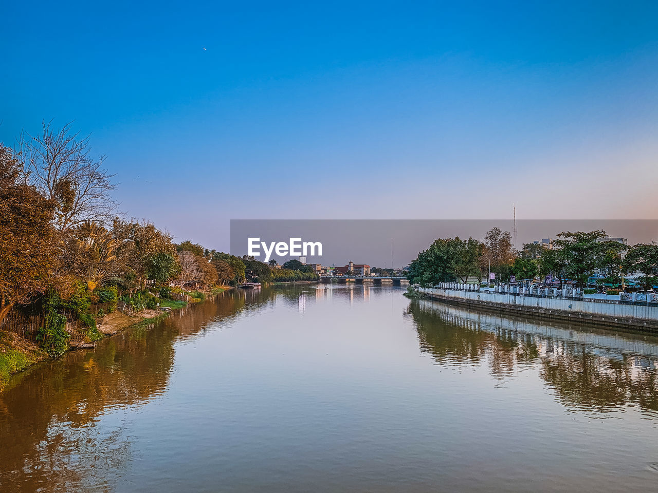 Scenic view of river against clear blue sky