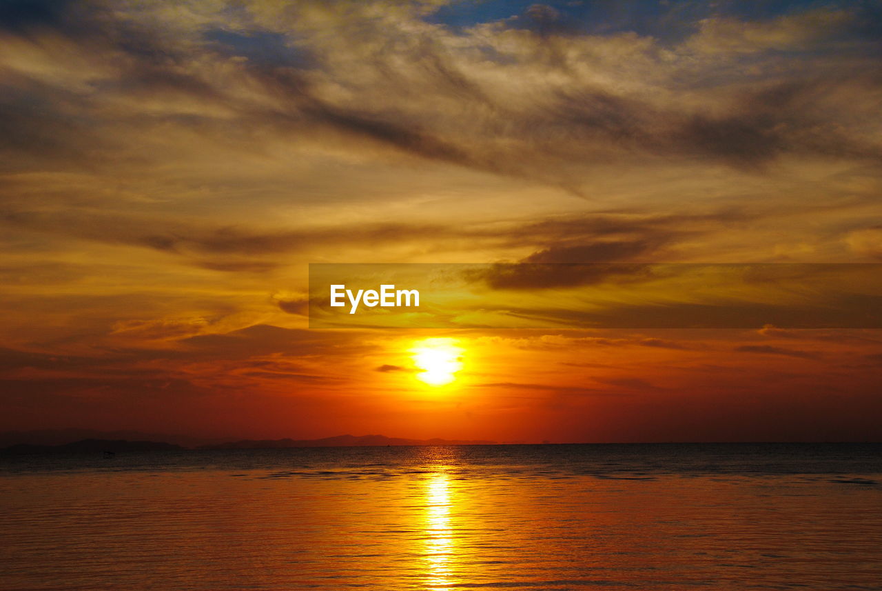 Scenic view of sea against romantic sky at sunset