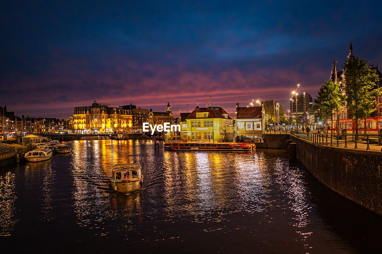 illuminated buildings in water