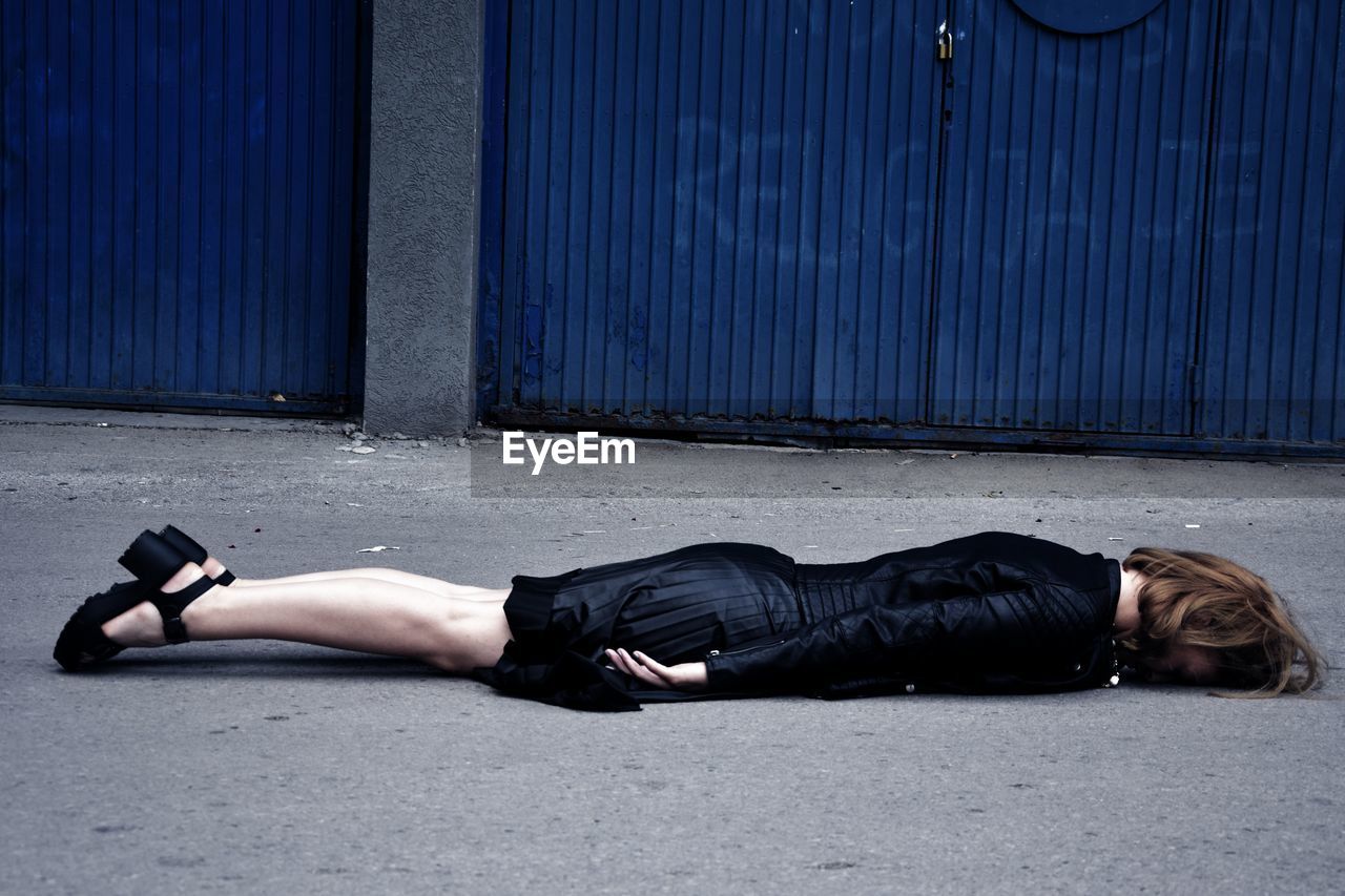 Woman lying down on street