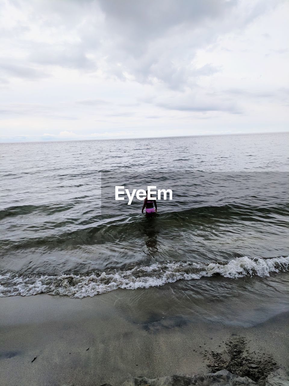 MAN ON SEA AGAINST SKY