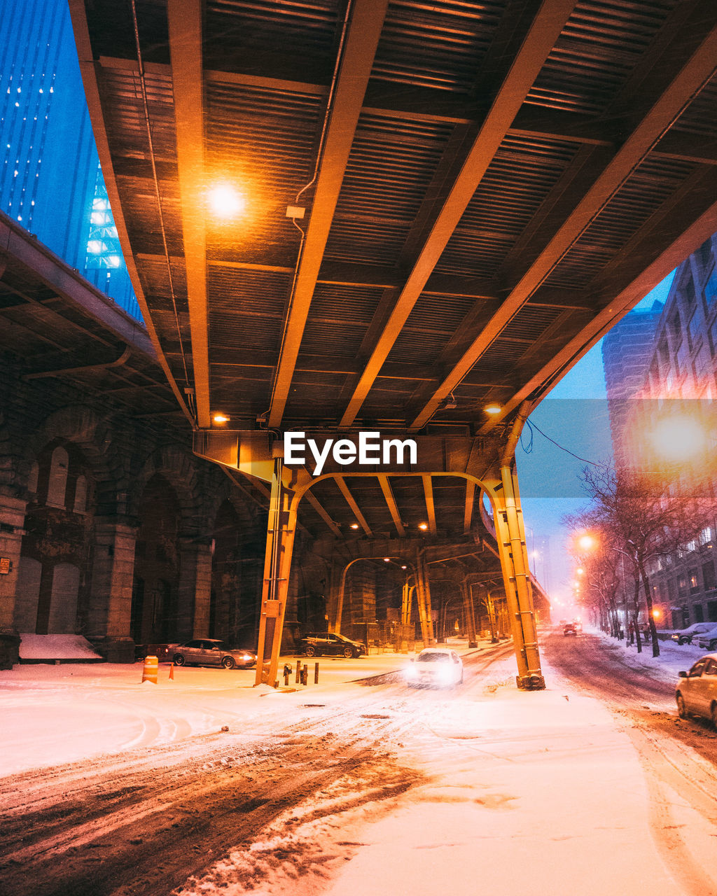 Snow covered road in city at night