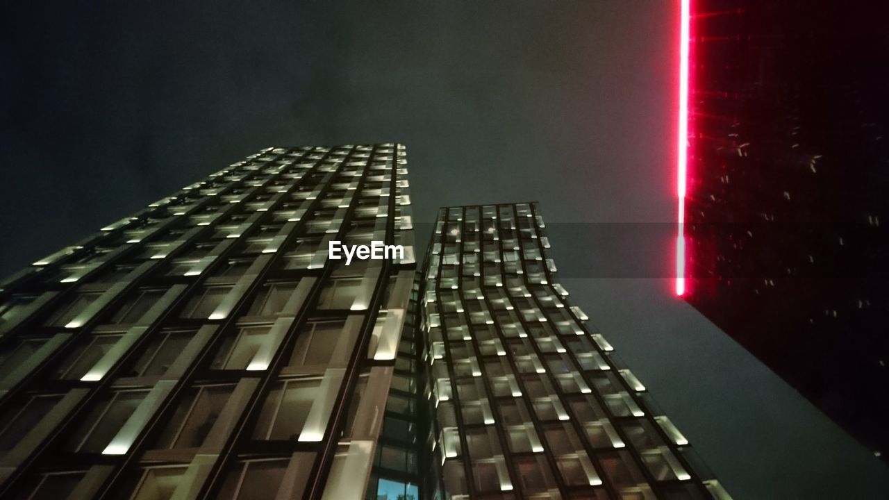 LOW ANGLE VIEW OF ILLUMINATED SKYSCRAPER