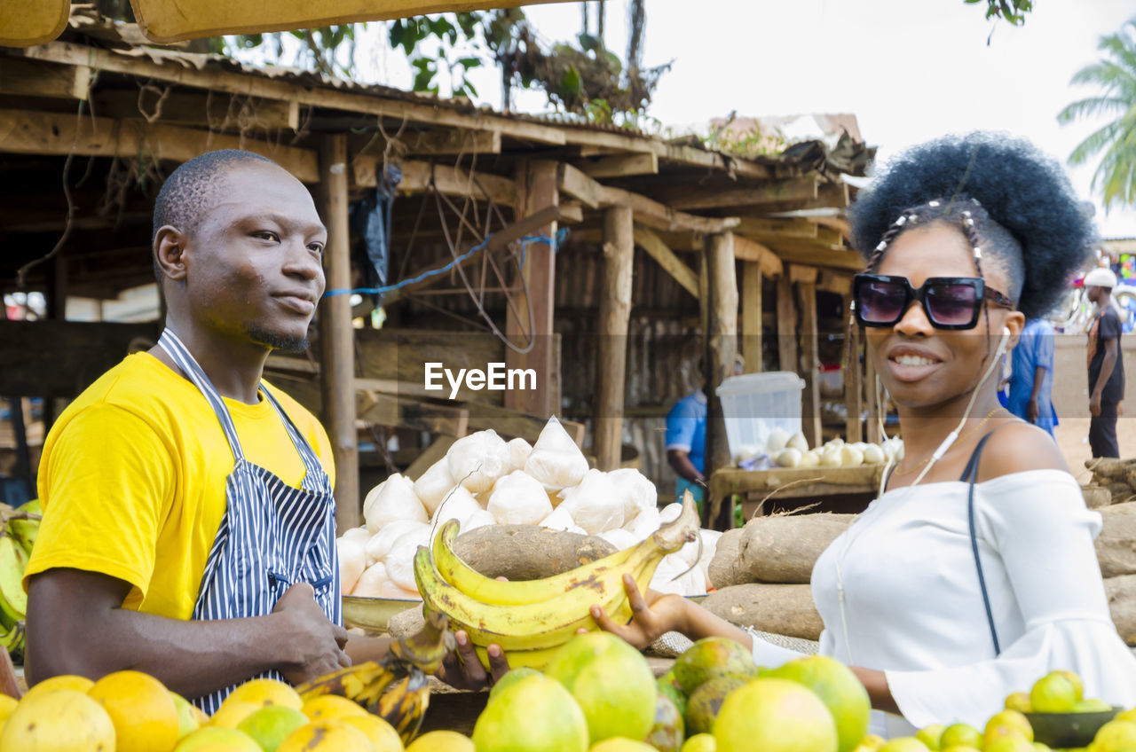 A young handsome african man feeling excited as he sells to his beautiful customer