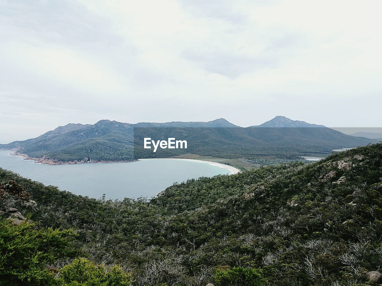 SCENIC VIEW OF LAKE BY MOUNTAIN AGAINST SKY