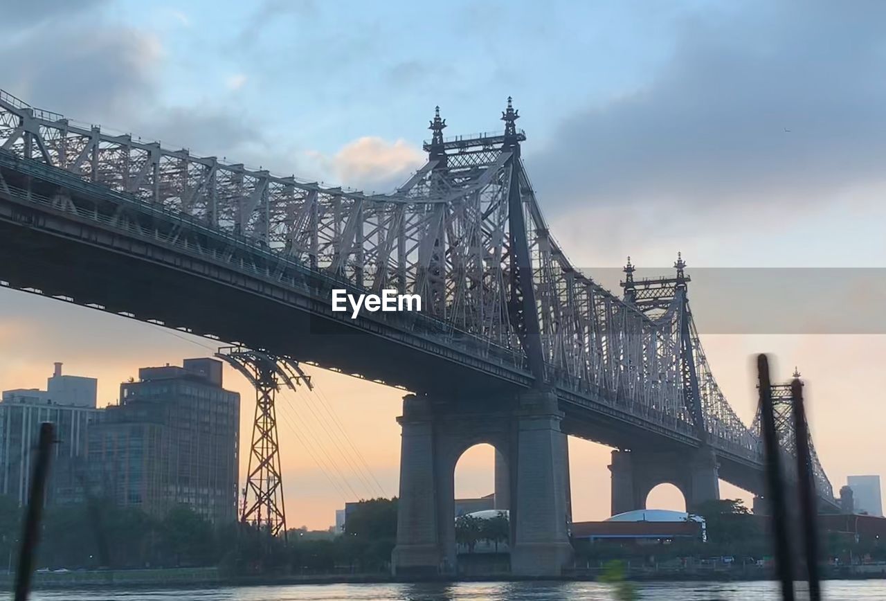 LOW ANGLE VIEW OF BRIDGE AGAINST CLOUDY SKY