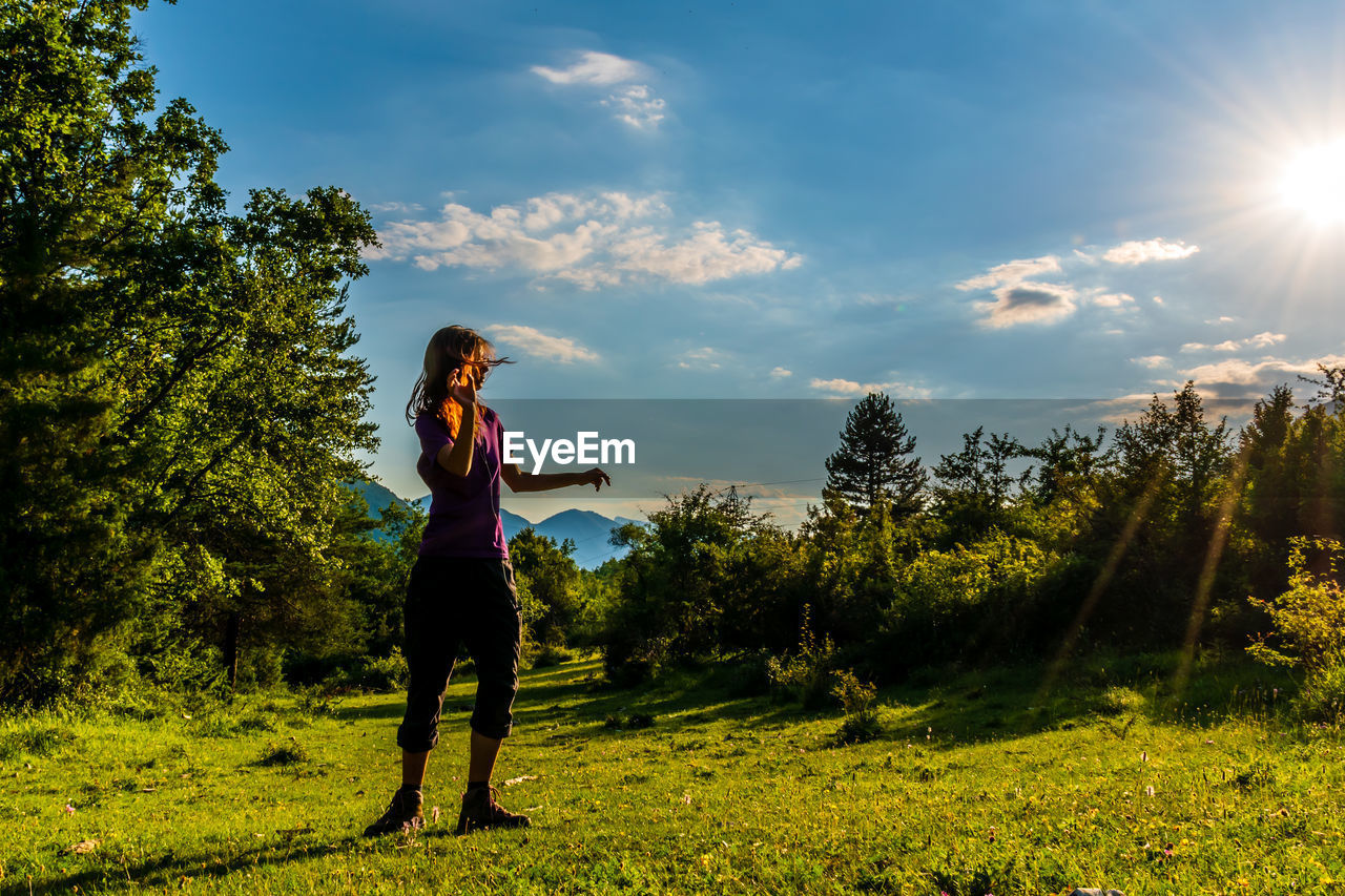Man standing on land against sky