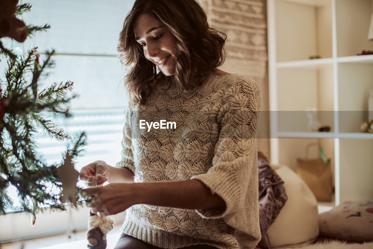 YOUNG WOMAN LOOKING AT HOME