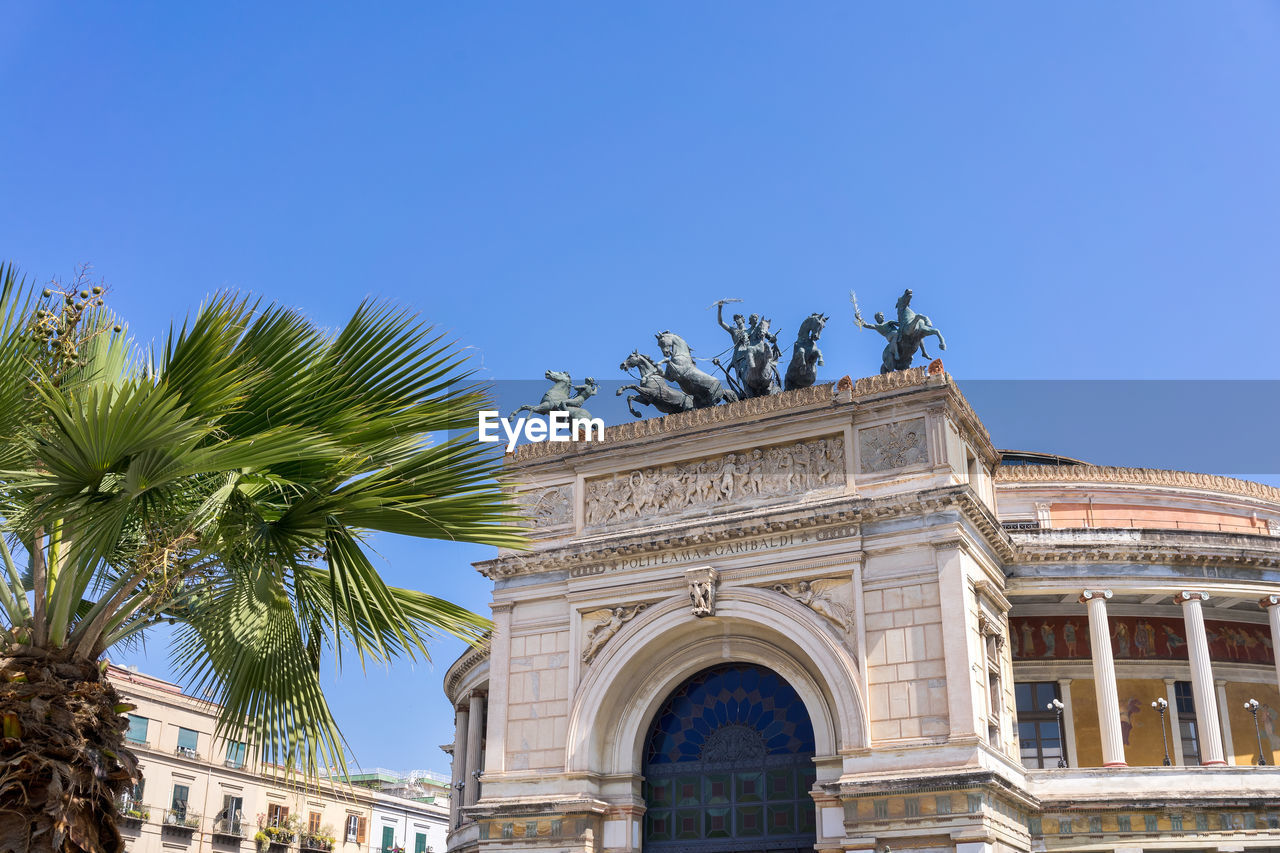 Low angle view of historic building against clear blue sky