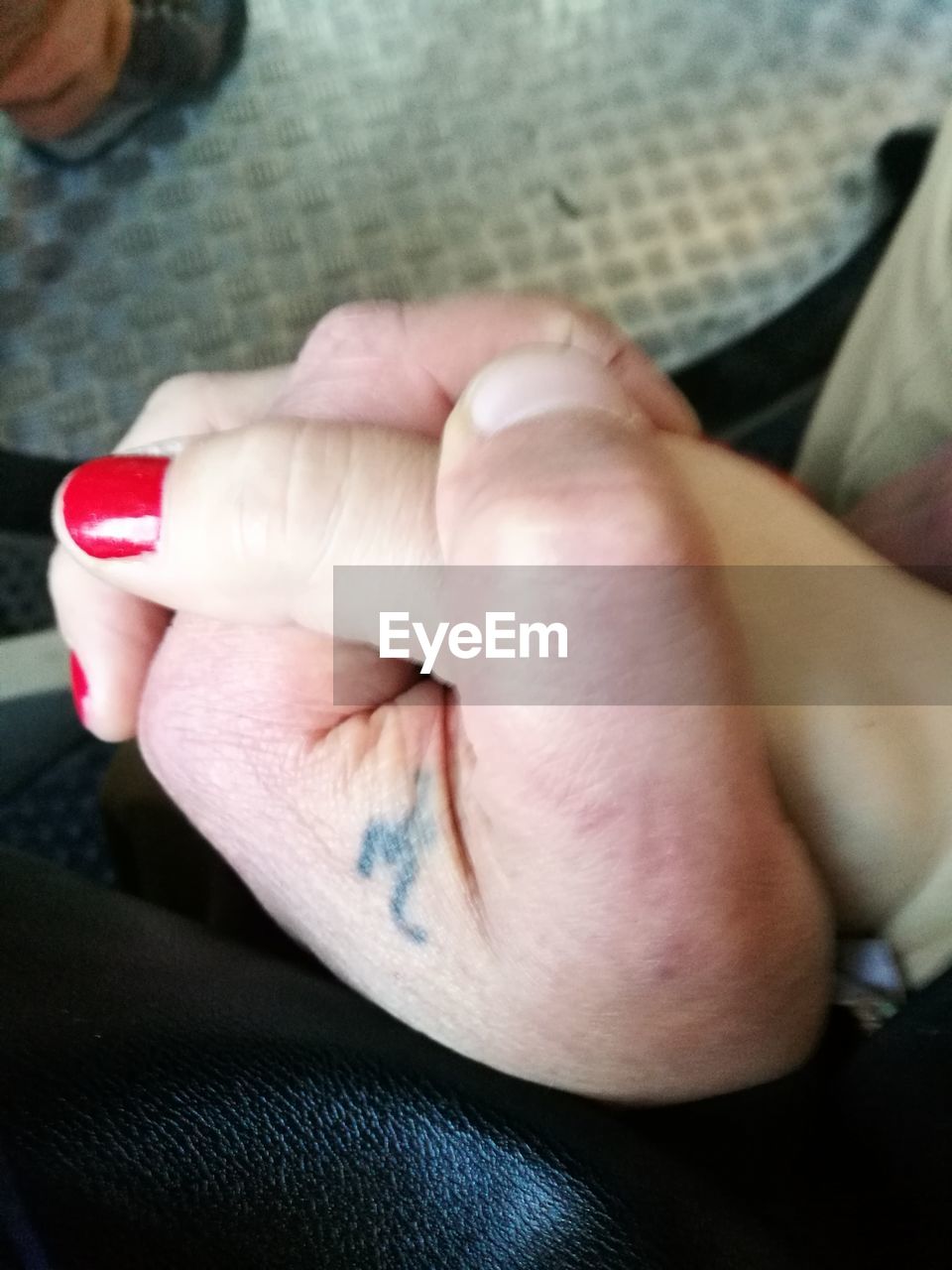 CLOSE-UP OF WOMAN HAND WITH TATTOO