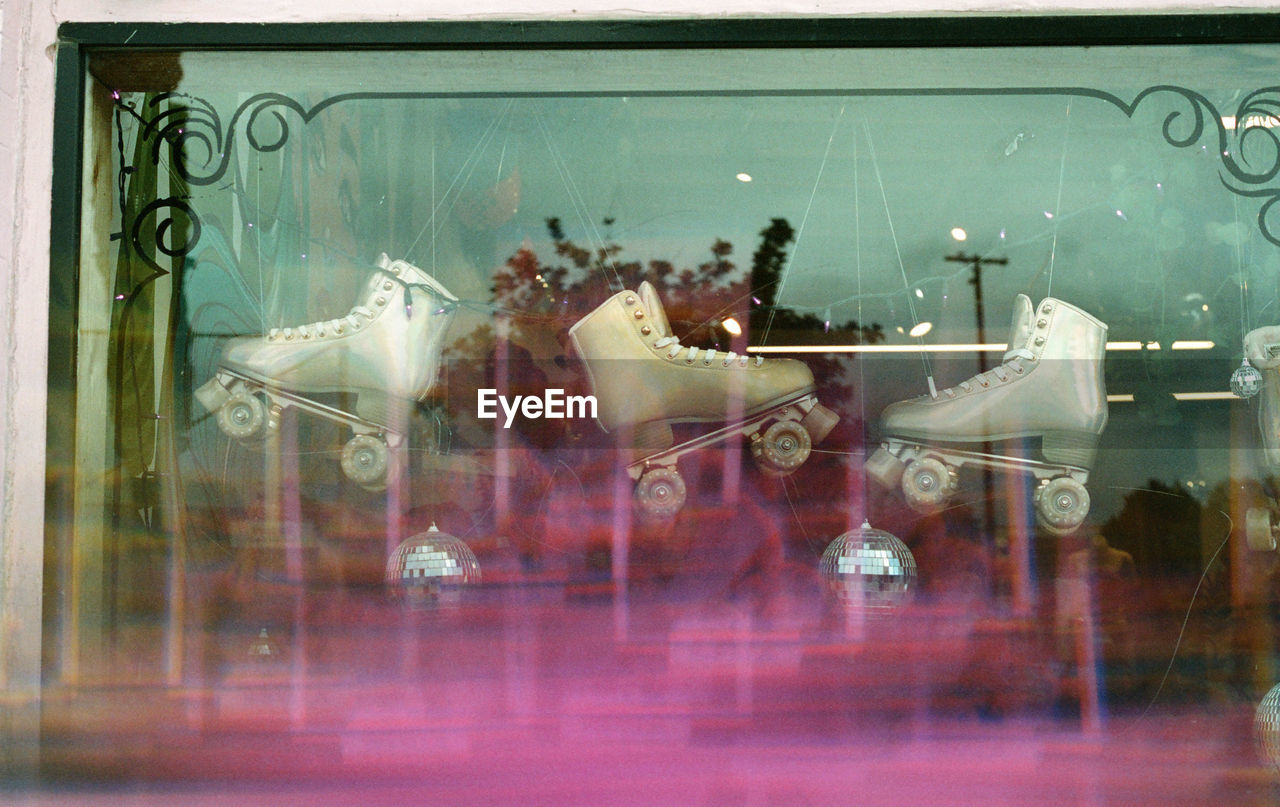 rear view of woman standing in glass window