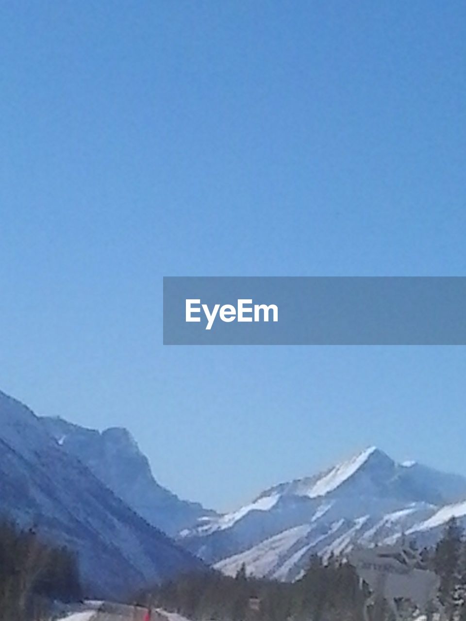 SNOW COVERED LANDSCAPE AGAINST CLEAR SKY