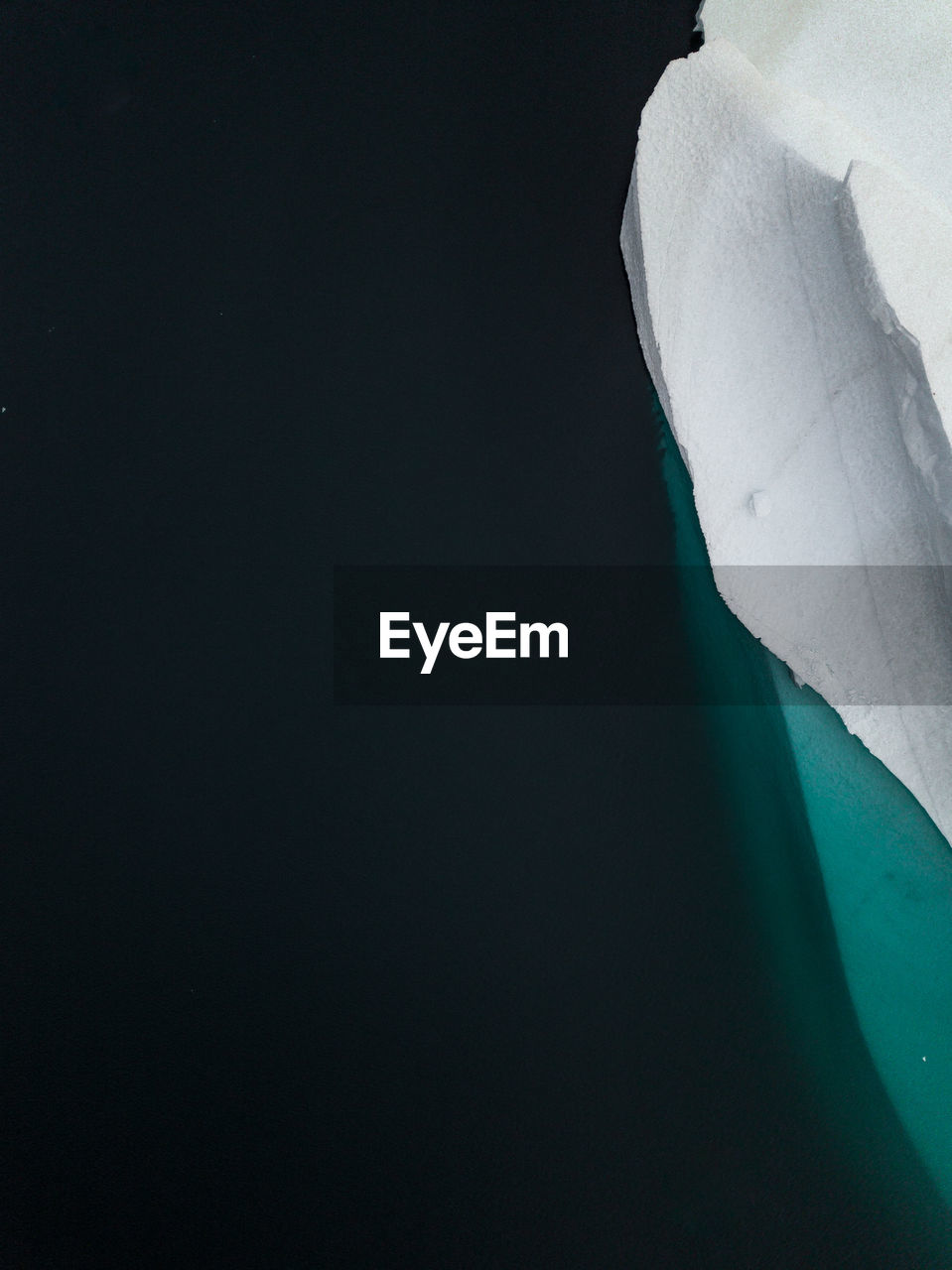 Aerial view of iceberg melting in sea