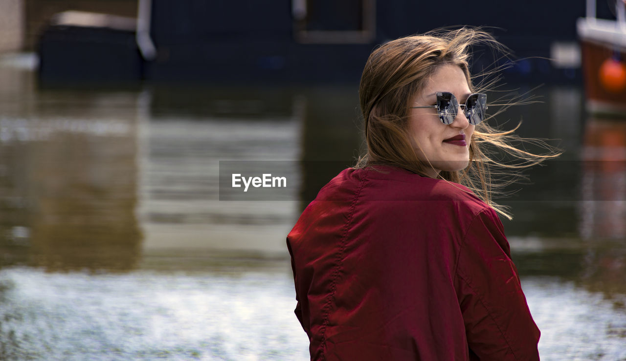 Rear view of smiling young woman wearing sunglasses