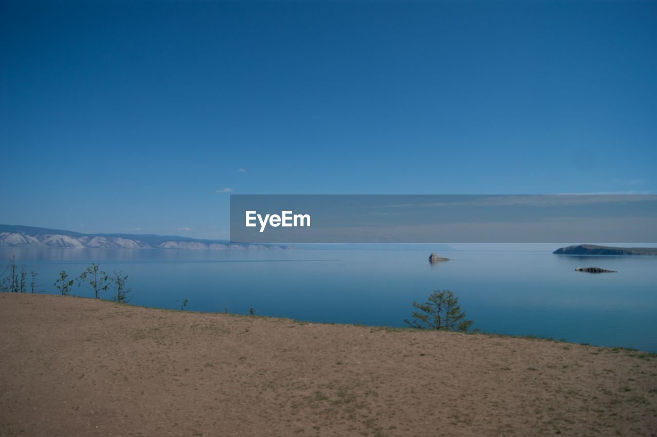 Scenic view of sea against blue sky