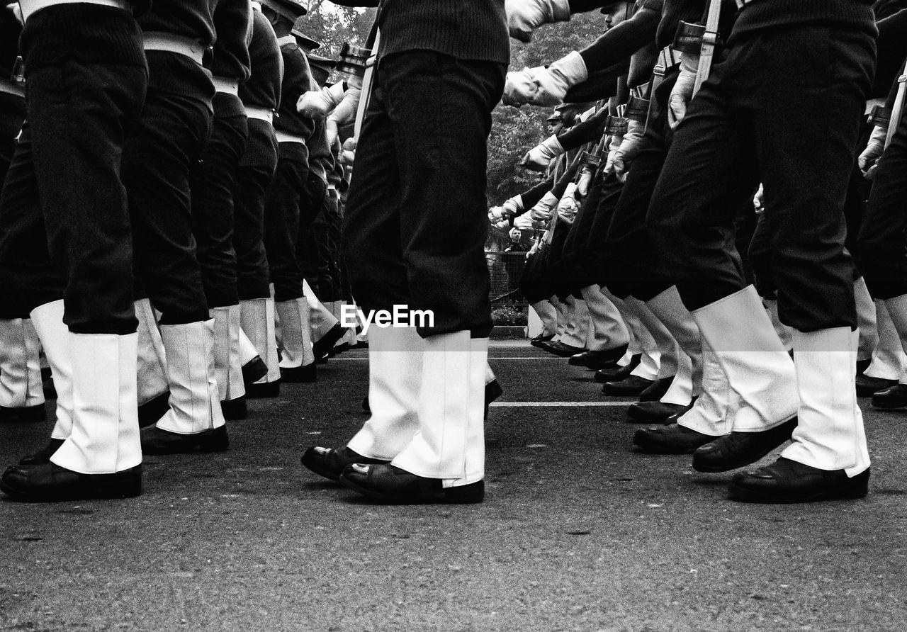 Low section of people standing on street