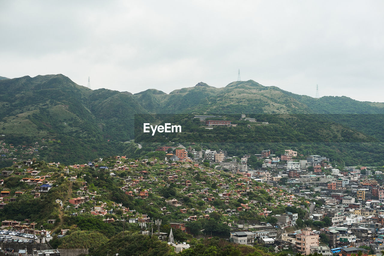 High angle view of townscape and mountains against sky