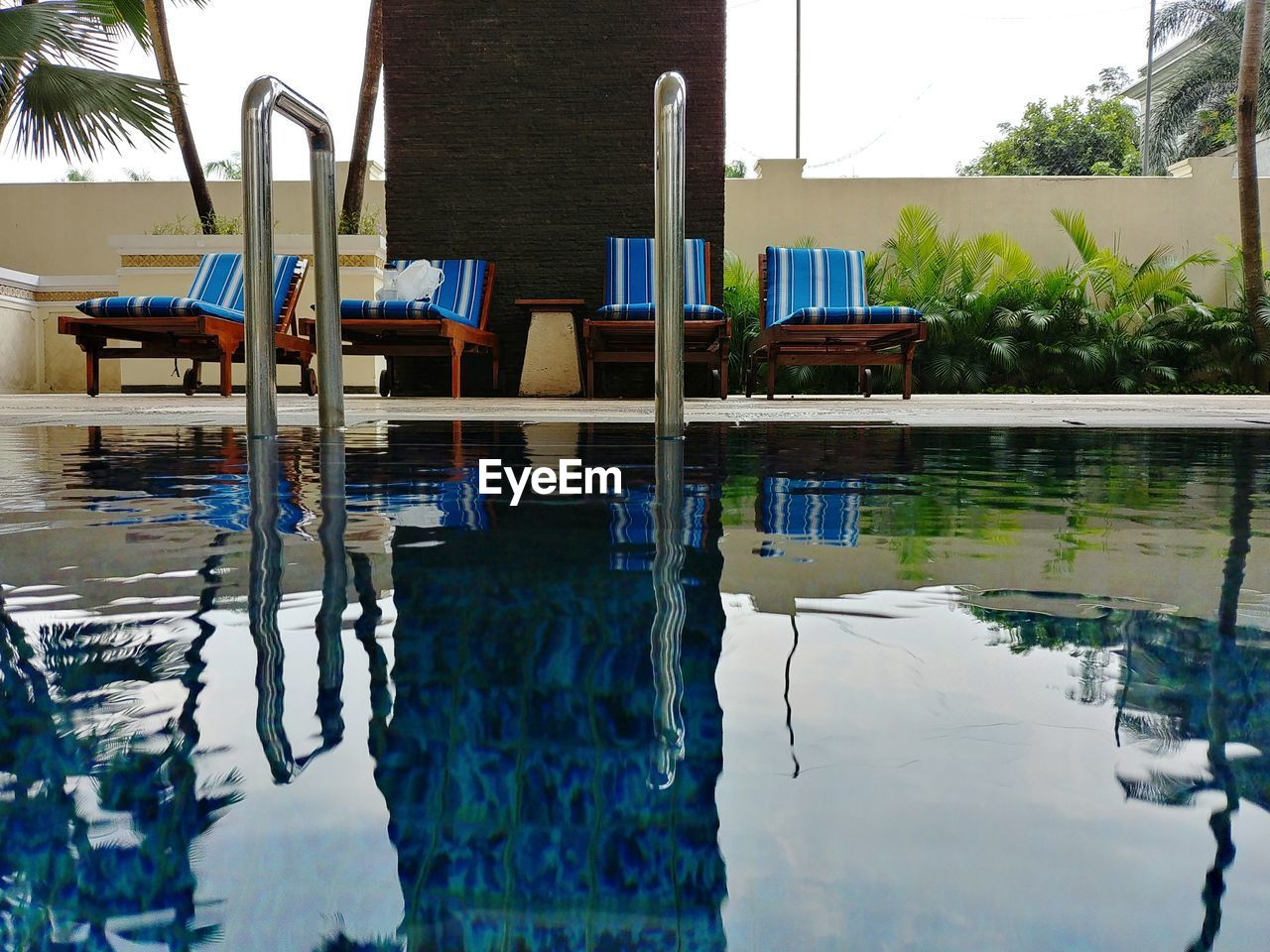 VIEW OF SWIMMING POOL BY LAKE AGAINST BUILDINGS