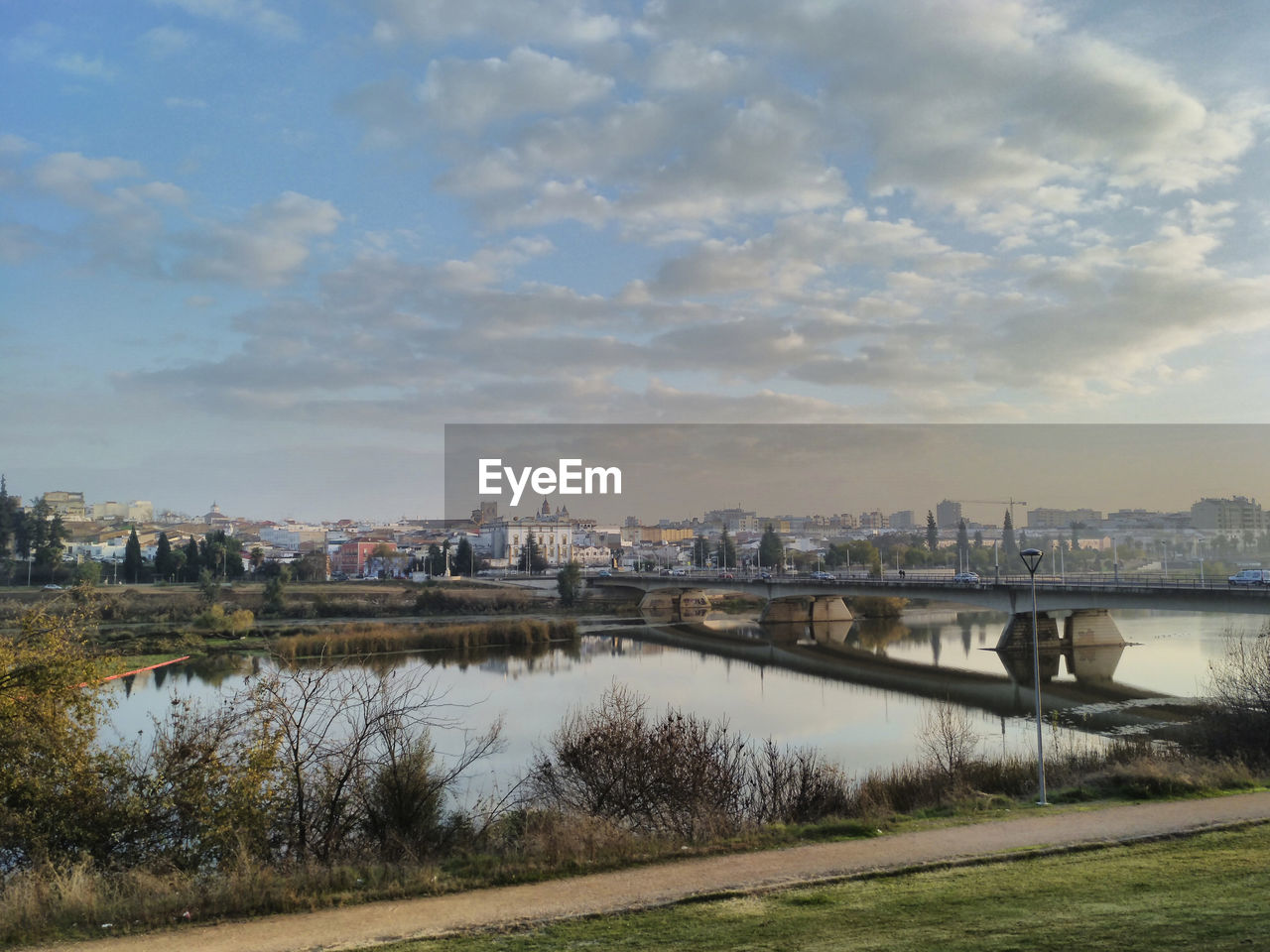 View of bridge over river against cloudy sky