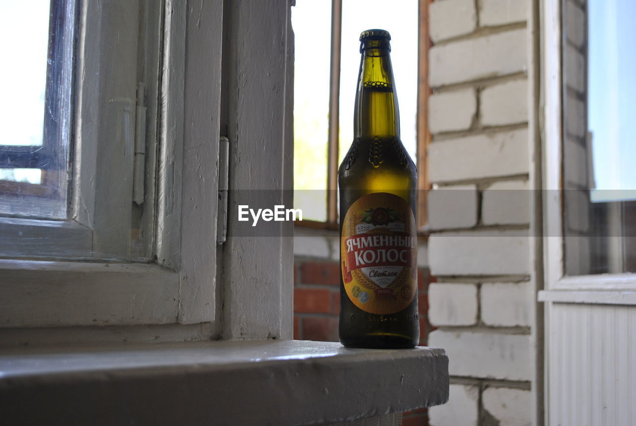 CLOSE-UP OF BEER GLASS ON TABLE