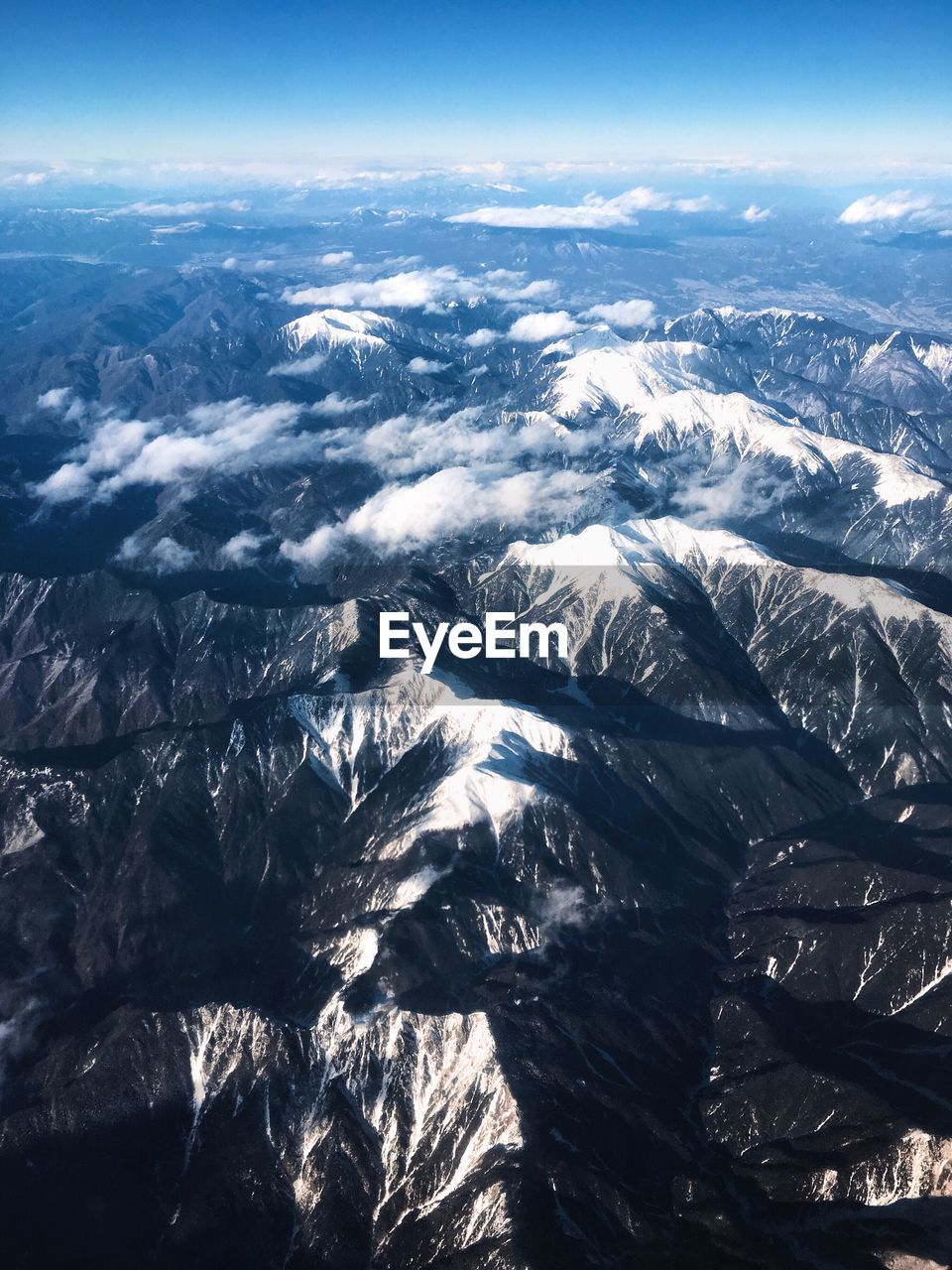 AERIAL VIEW OF SNOW COVERED LANDSCAPE