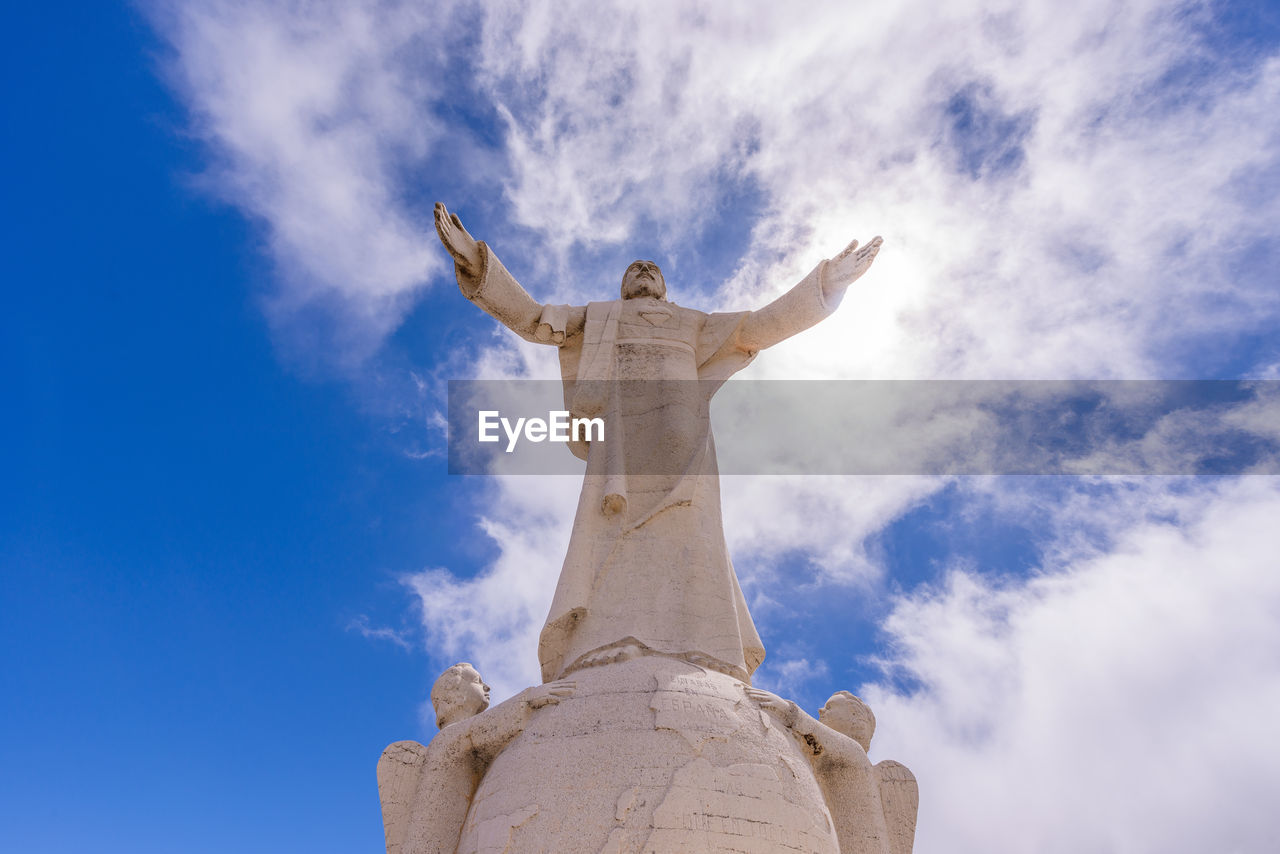 Low angle view of statue against cloudy sky