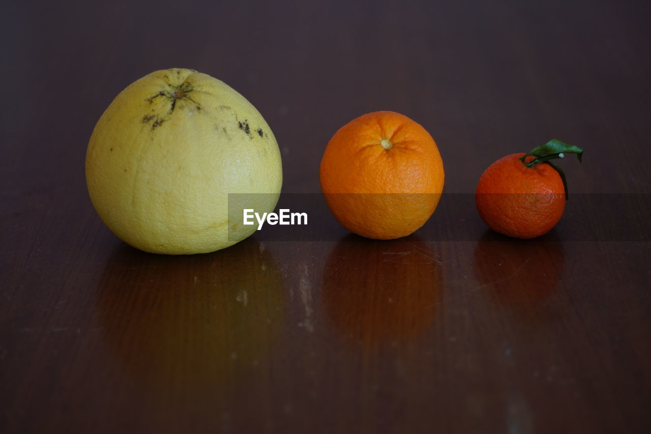 CLOSE-UP OF FRUITS ON TABLE