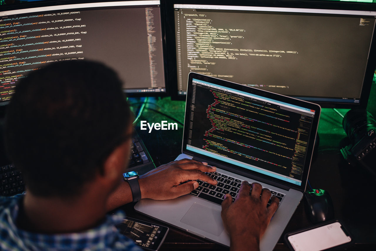 Close-up of computer programmer working at office