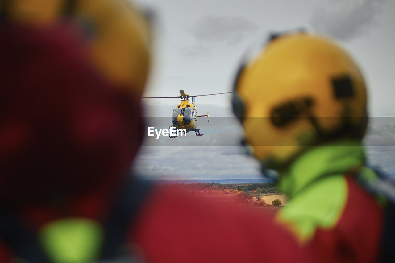 Paramedics as they looking at the approaching helicopter of emergency medical service. 