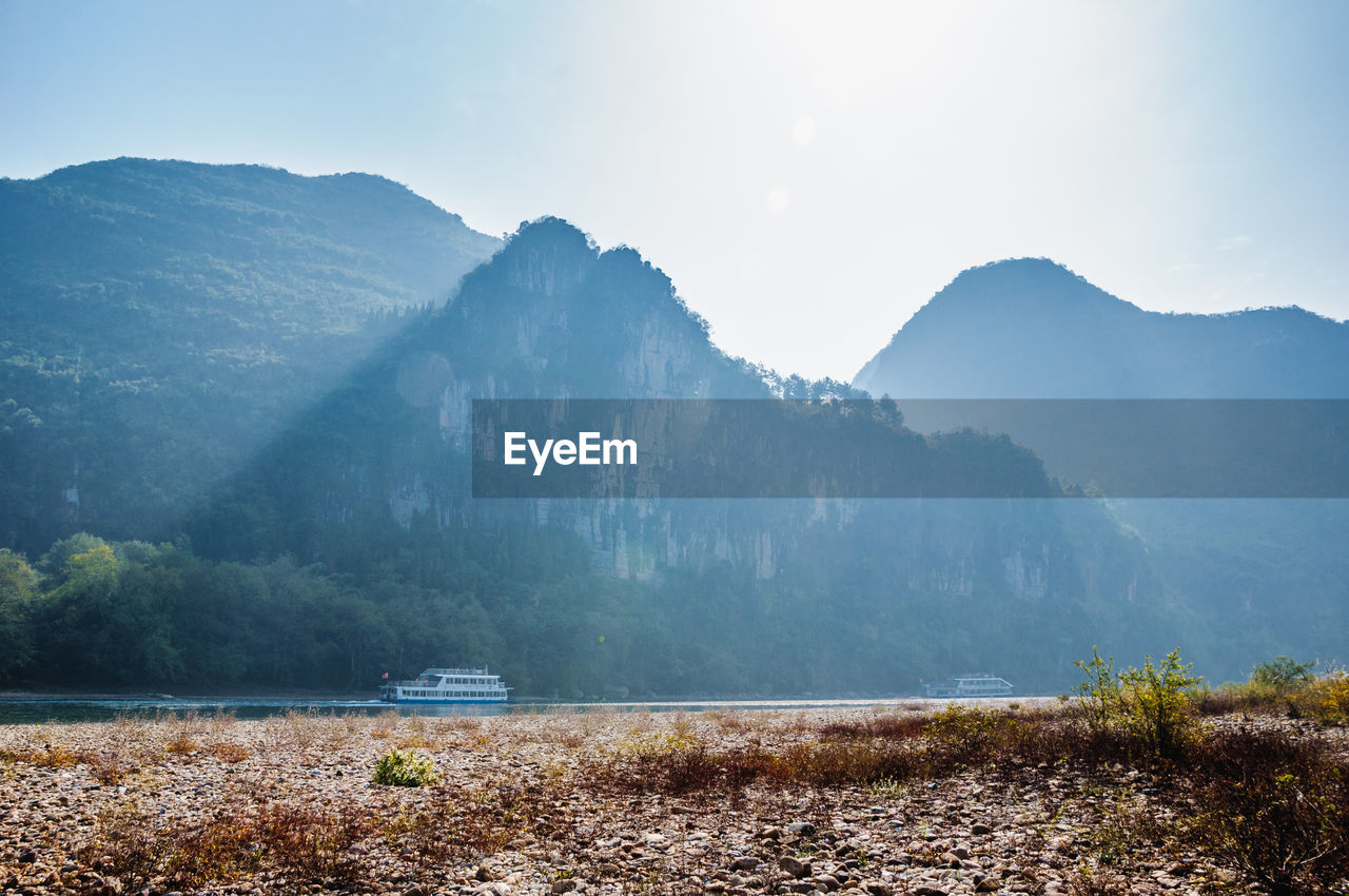 Scenic view of lake and mountains against sky