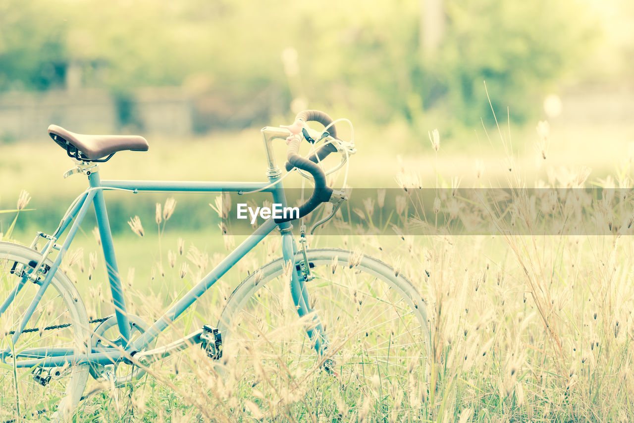 Bicycle on grassy field against sky