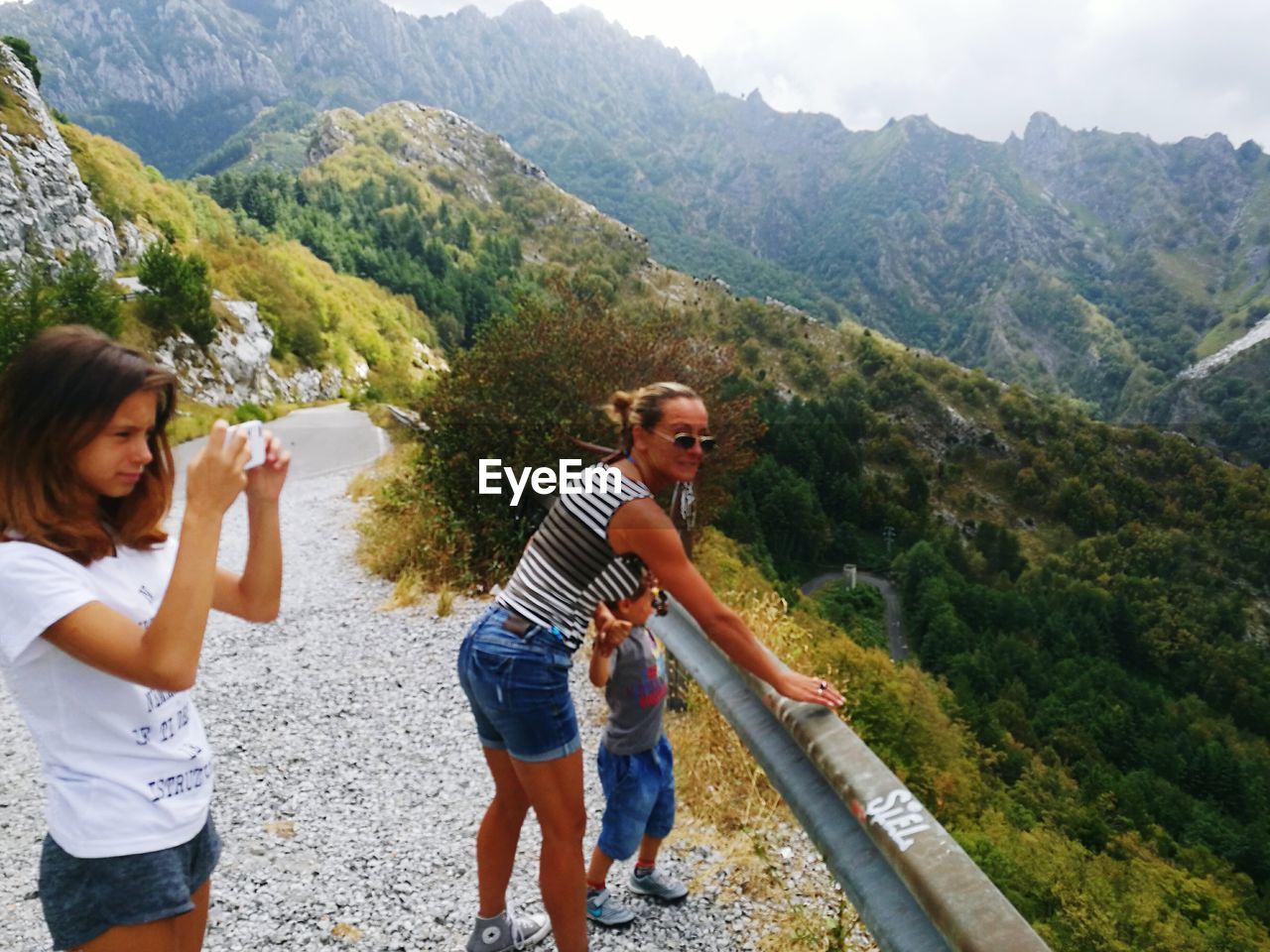 Family standing against mountain at observation point