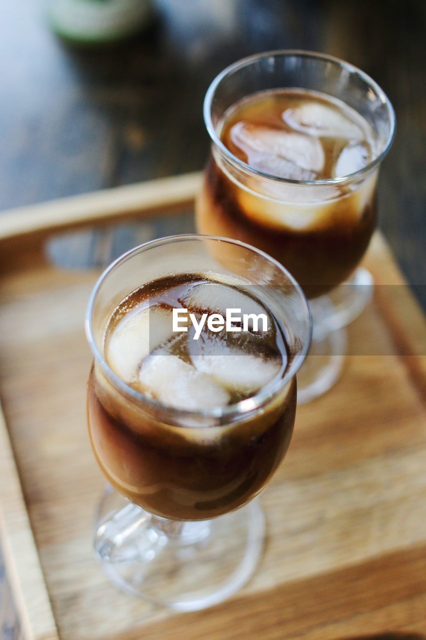 High angle view of ice coffee in glasses on table