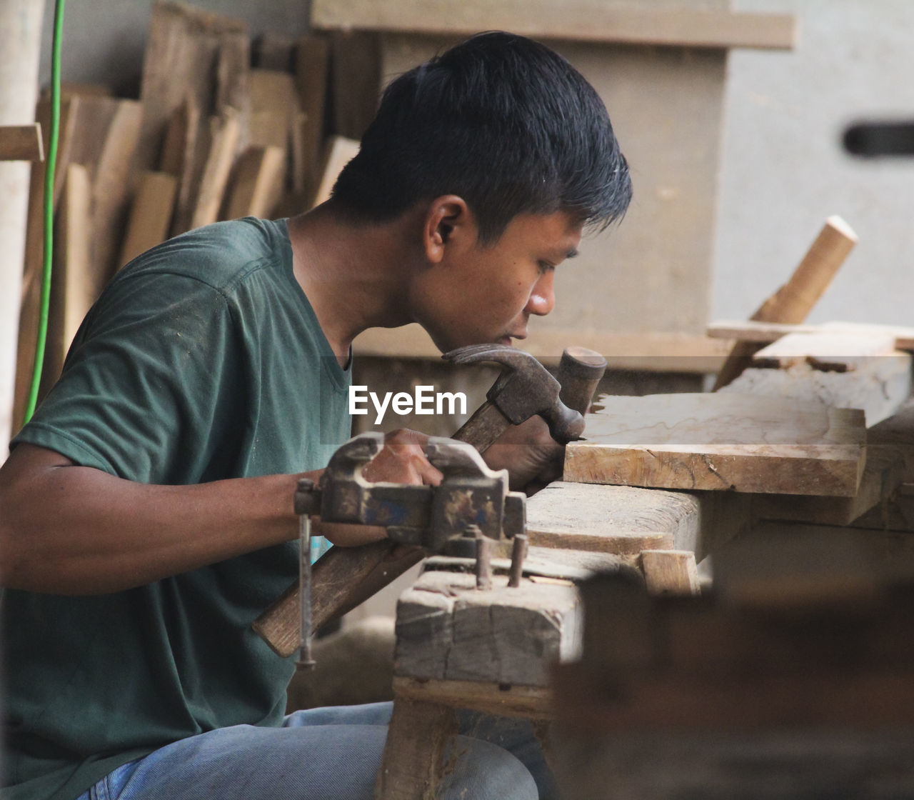 Side view of man working at workshop