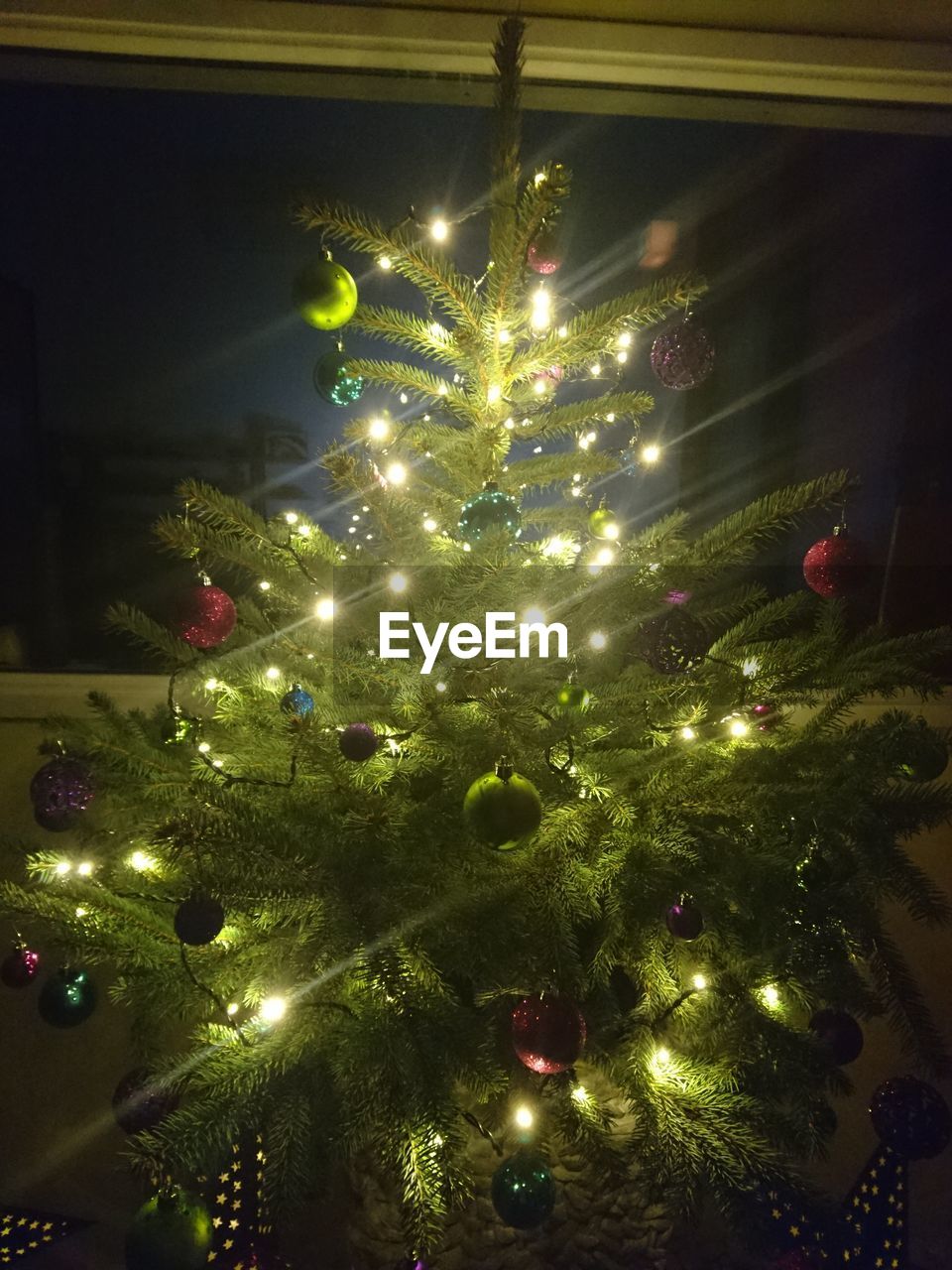 ILLUMINATED CHRISTMAS TREE IN SKY AT NIGHT