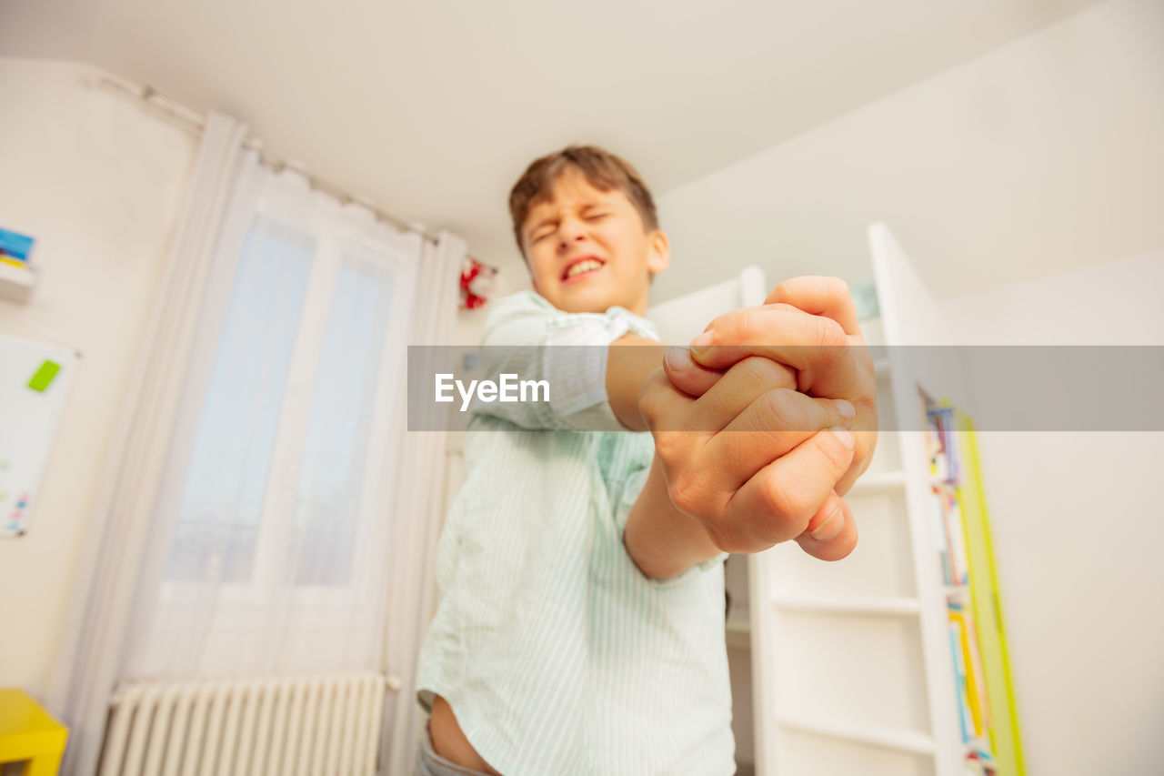 high angle view of cute baby boy with daughter at home