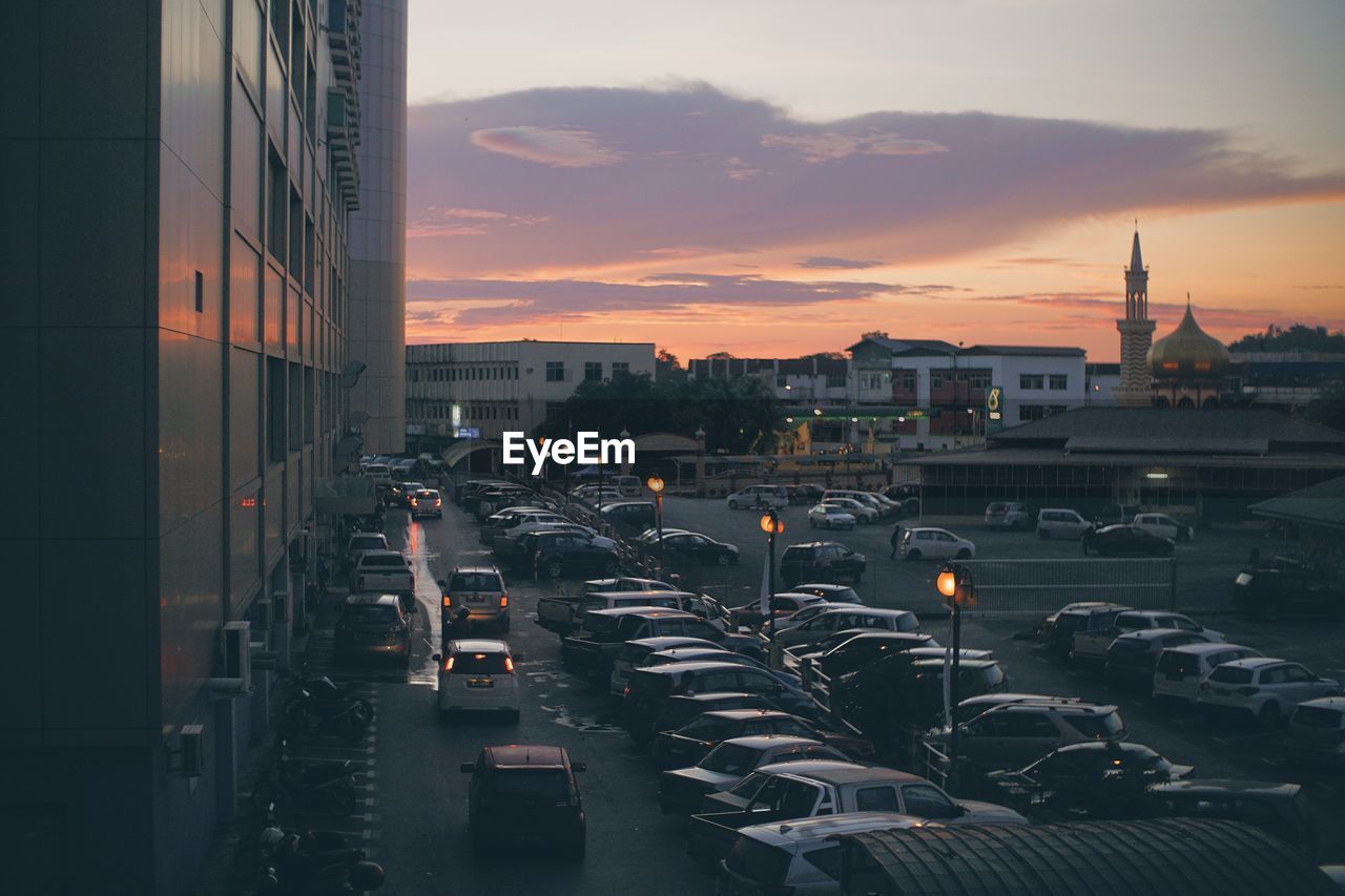 Aerial view of city against sky during sunset