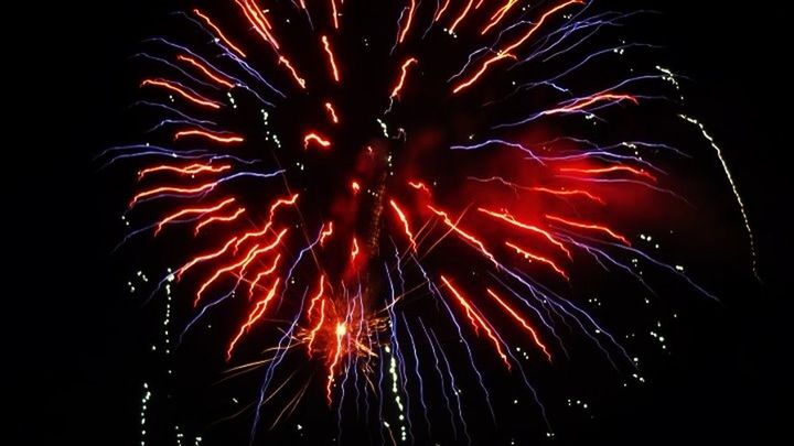 LOW ANGLE VIEW OF FIREWORKS EXPLODING