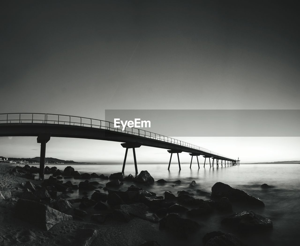 Bridge over sea against clear sky