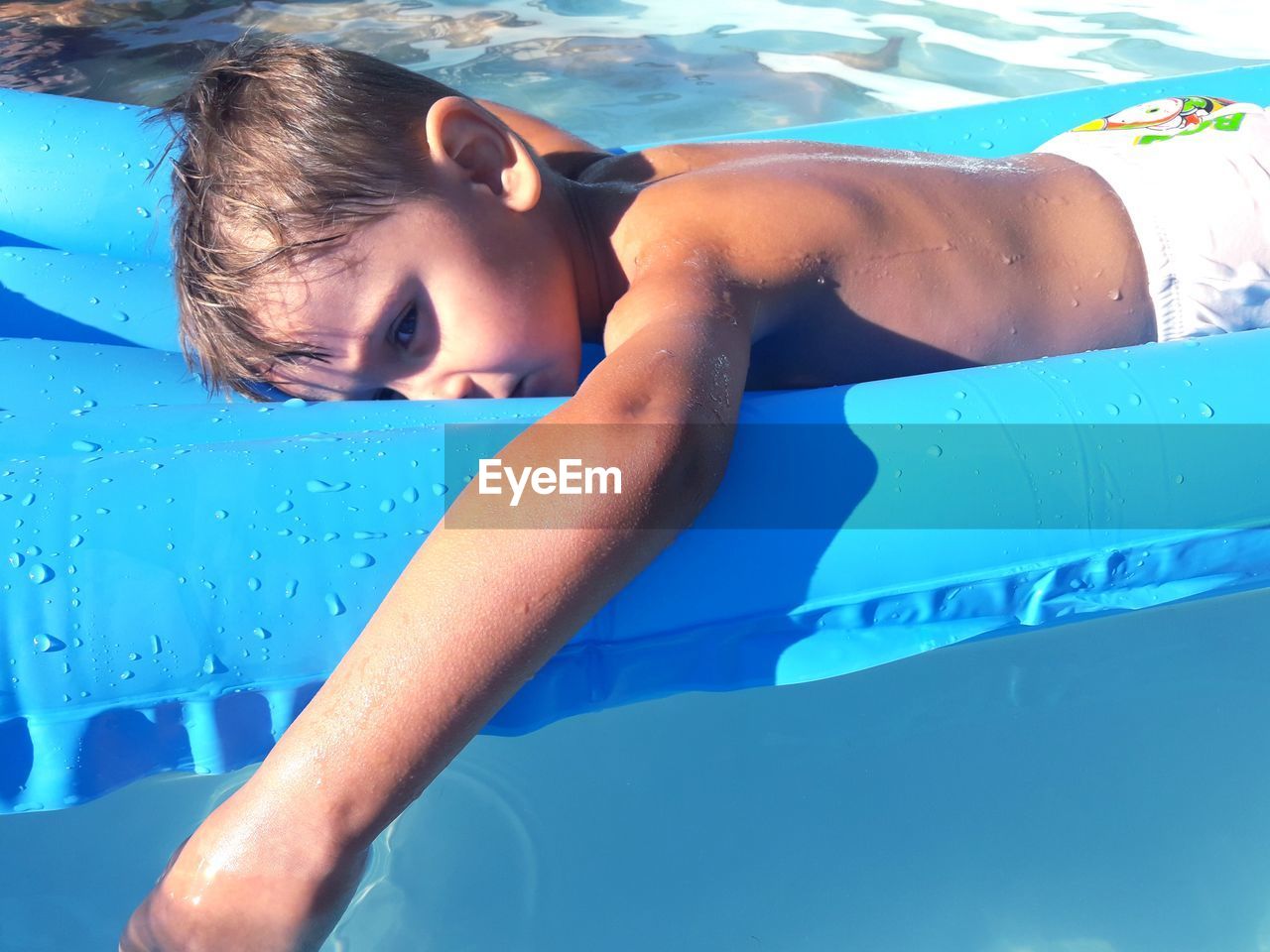 GIRL RELAXING ON SWIMMING POOL