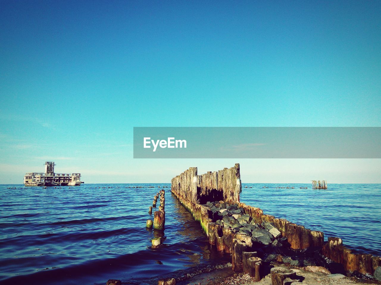 Scenic view of sea against clear blue sky